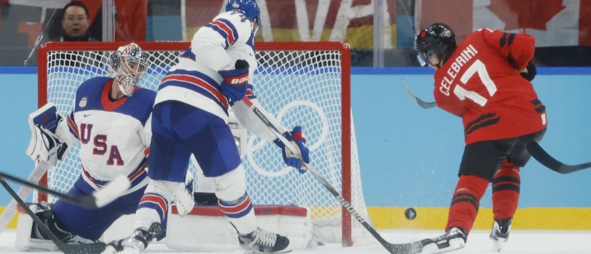 Macklin Celebrini (17) of Canada shoots against Connor Hellebuyck (37) of the United States in the men's ice hockey gold medal game during the Milano Cortina 2026 Olympic Winter Games at Milano Santagiulia Ice Hockey Arena