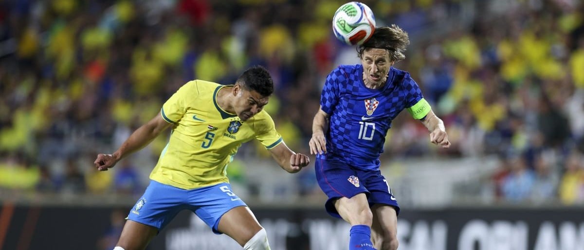 Croatia midfielder Luka Modric (10) heads the ball [past Brazil midfielder Casemiro (5) in the first half during an international friendly at Camping World Stadium