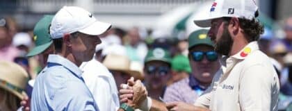 Rory McIlroy greets Cameron Young before teeing off on the first hole during the final round of the Masters Tournament at Augusta National Golf Club.
