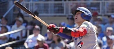 Toronto Blue Jays third baseman Kazuma Okamoto (7) hits a two run home run against the Minnesota Twins in the ninth inning at Target Field.
