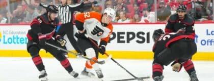 Philadelphia Flyers center Denver Barkey (52) skates with the puck against Carolina Hurricanes left wing Eric Robinson (50) and defenseman Sean Walker (26) during the second period in game two of the second round of the 2026 Stanley Cup Playoffs at Lenovo Center.