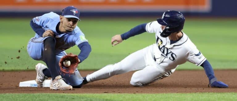 Tampa Bay Rays right fielder Jonny DeLuca (21) steals second base from Toronto Blue Jays shortstop Andres Gimenez (0) in the seventh inning at Tropicana Field