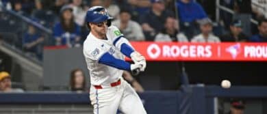 Toronto Blue Jays second base Ernie Clement (22) hits a single in the fourth inning against the Los Angeles Angels at Rogers Centre