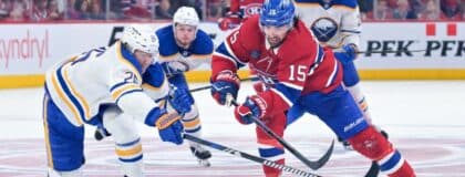 Montreal Canadiens forward Alex Newhook (15) on his way to score an empty net goal and Buffalo Sabres defenseman Rasmus Dahlin (26) defending during the third period in game three of the second round of the 2026 Stanley Cup Playoffs at the Bell Centre.