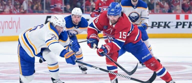 Montreal Canadiens forward Alex Newhook (15) on his way to score an empty net goal and Buffalo Sabres defenseman Rasmus Dahlin (26) defending during the third period in game three of the second round of the 2026 Stanley Cup Playoffs at the Bell Centre.