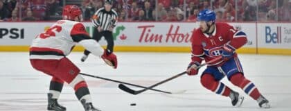 Montreal Canadiens center Nick Suzuki (14) skates against Carolina Hurricanes defenseman Sean Walker (26) during the third period in game three of the Eastern Conference Final of the 2026 Stanley Cup Playoffs at Bell Centre