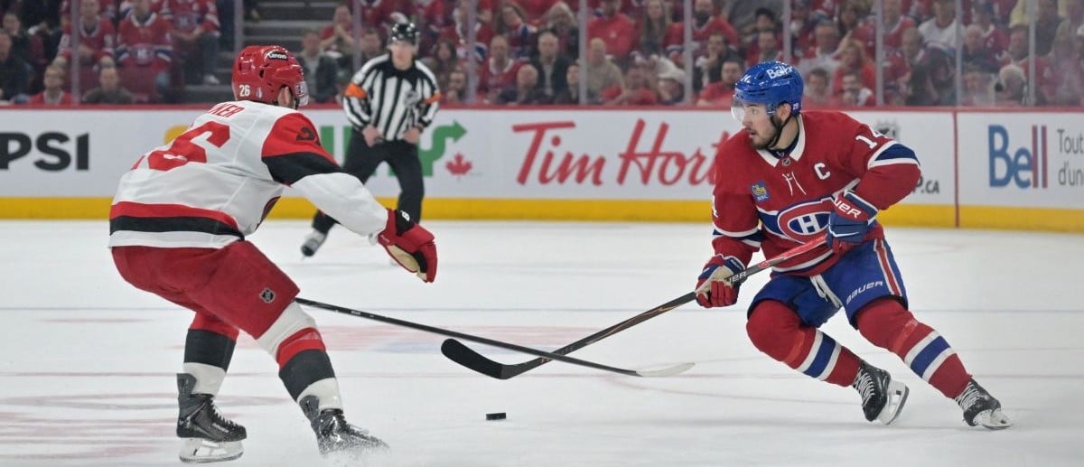 Montreal Canadiens center Nick Suzuki (14) skates against Carolina Hurricanes defenseman Sean Walker (26) during the third period in game three of the Eastern Conference Final of the 2026 Stanley Cup Playoffs at Bell Centre