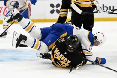 Apr 23, 2026; Boston, Massachusetts, USA; Buffalo Sabres center Peyton Krebs (19) collides with Boston Bruins defenseman Charlie McAvoy (73) during the second period of game three of the first round of the 2026 Stanley Cup Playoffs at the TD Garden.