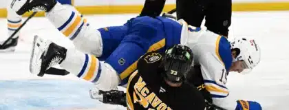 Apr 23, 2026; Boston, Massachusetts, USA; Buffalo Sabres center Peyton Krebs (19) collides with Boston Bruins defenseman Charlie McAvoy (73) during the second period of game three of the first round of the 2026 Stanley Cup Playoffs at the TD Garden.