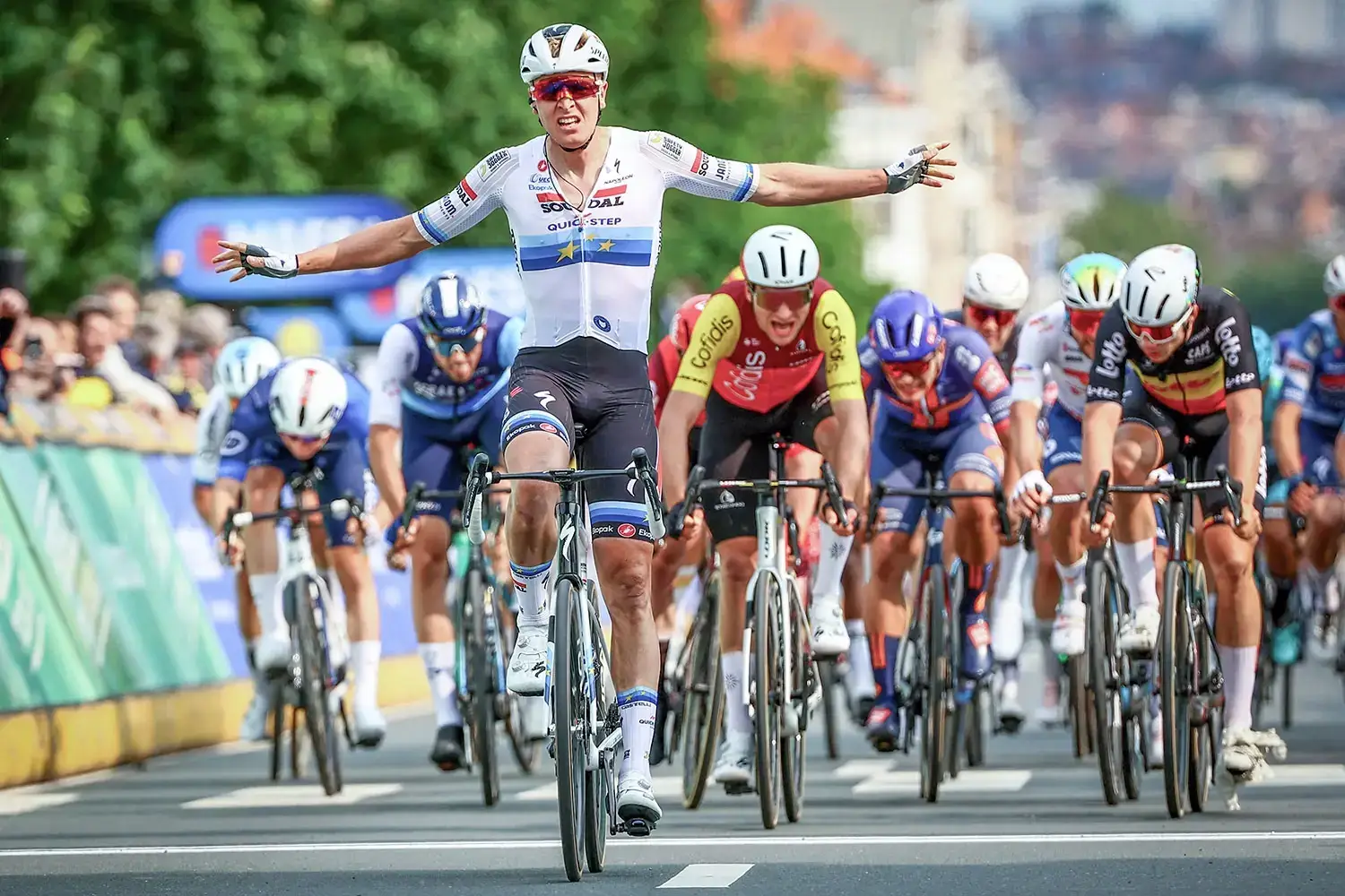 European champion Tim Merlier crossing the finish line in a cycling race