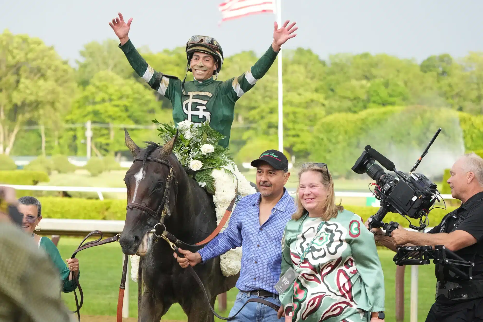 Jose L. Oriz reacts to winning the Belmont Stakes on Golden Tempo (9) with owner Daisy Phipps Pulito. Jun 6, 2026; Saratoga Springs, NY, USA.