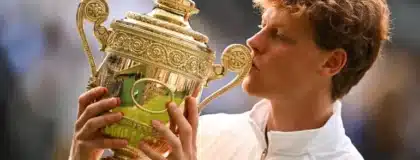 Jannik Sinner kisses the trophy after beating Carlos Alcaraz in the men's singles final of the 2025 Wimbledon Championships at the All England Lawn Tennis and Croquet Club in London