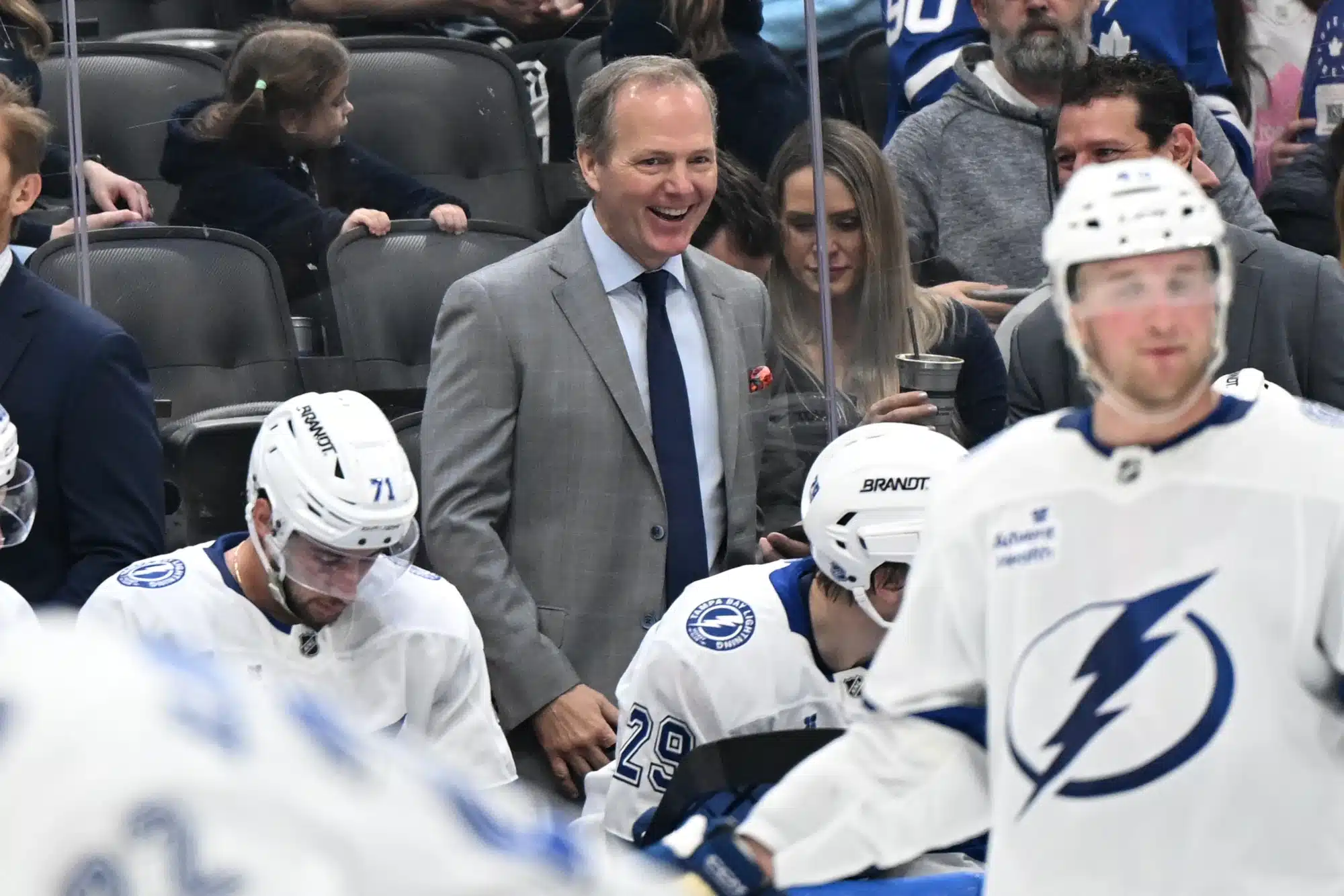 Mar 7, 2026; Toronto, Ontario, CAN; Tampa Bay Lightning head coach Jon Cooper enjoys a light moment on the bench during a time out against the Toronto Maple Leafs in the second period at Scotiabank Arena.