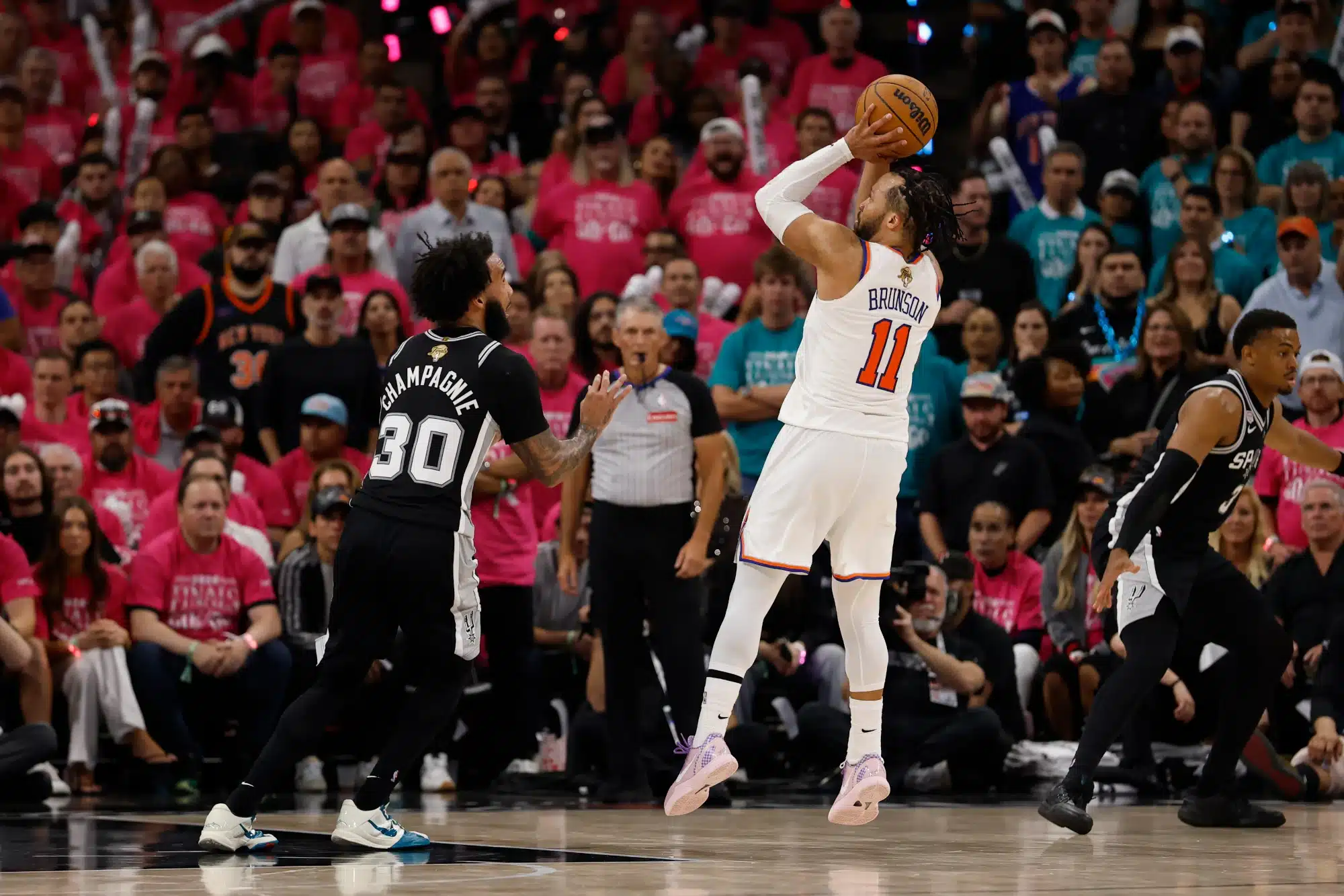 Jun 3, 2026; San Antonio, Texas, USA; New York Knicks guard Jalen Brunson (11) shoots the ball past San Antonio Spurs forward Julian Champagnie (30) in the second half during game one of the 2026 NBA Finals at Frost Bank Center.