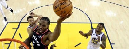 Toronto Raptors forward Kawhi Leonard (2) shoots the ball against Golden State Warriors forward Draymond Green (23) in game three of the 2019 NBA Finals at Oracle Arena.