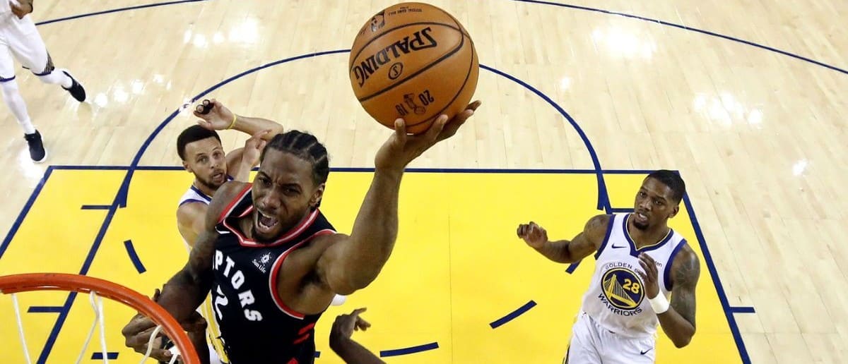 Toronto Raptors forward Kawhi Leonard (2) shoots the ball against Golden State Warriors forward Draymond Green (23) in game three of the 2019 NBA Finals at Oracle Arena.