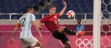 Team Spain forward Dani Olmo (19) kicks the ball in front of Team Argentina defender Patricio Perez (2) during the Tokyo 2020 Olympic Summer Games at Saitama Stadium