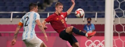Team Spain forward Dani Olmo (19) kicks the ball in front of Team Argentina defender Patricio Perez (2) during the Tokyo 2020 Olympic Summer Games at Saitama Stadium