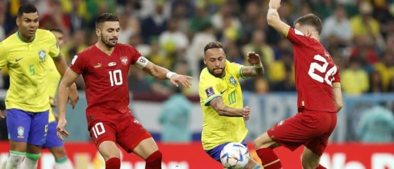 Brazil forward Neymar (10) kicks the ball past Serbia midfielder Sergej Milinkovic-Savic (20) during the second half in a group stage match during the 2022 World Cup at Lusail Stadium.