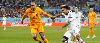 Netherlands defender Virgil van Dijk (4) dribbles the ball against United States of America midfielder Weston McKennie (8) during the second half of a round of sixteen match in the 2022 FIFA World Cup at Khalifa International Stadium