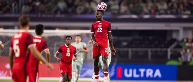Canada defender Richie Laryea (22) heads the ball against Mexico in the second half at AT&T Stadium