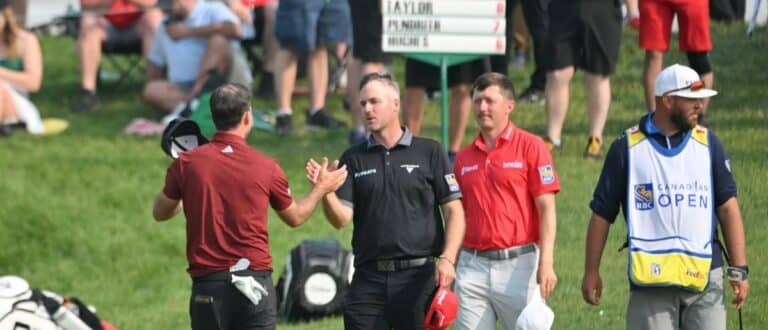 Nick Taylor (left) shakes hands with Taylor Pendrith and Mackenzie Hughes at the end of their round during the second round of the RBC Canadian Open golf tournament