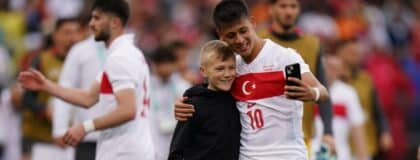 A soccer fan runs onto the field to get a photo with Turkey forward Arda Güler (10) after the game against team USA in the second half at Pratt & Whitney Stadium at Rentschler Field