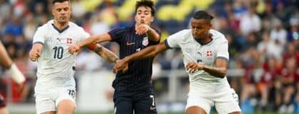 Switzerland midfielder Granit Xhaka (10) and defender Manuel Akanji (5) fights for the ball with United States forward Quinn Sullivan (7) during the first at Geodis Park.