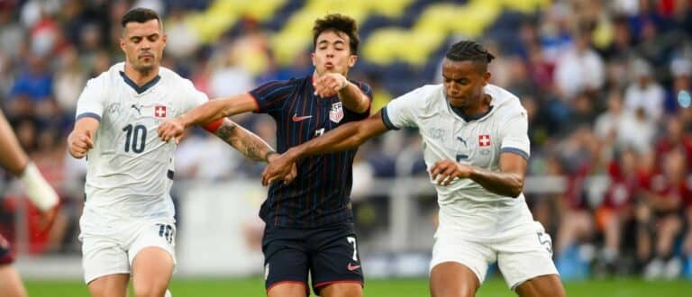 Switzerland midfielder Granit Xhaka (10) and defender Manuel Akanji (5) fights for the ball with United States forward Quinn Sullivan (7) during the first at Geodis Park.