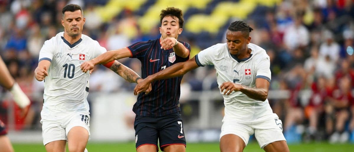 Switzerland midfielder Granit Xhaka (10) and defender Manuel Akanji (5) fights for the ball with United States forward Quinn Sullivan (7) during the first at Geodis Park.