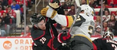 Carolina Hurricanes defenseman Sean Walker (26) checks Vegas Golden Knights center Brett Howden (21) during the second period at Lenovo Center