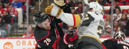 Carolina Hurricanes defenseman Sean Walker (26) checks Vegas Golden Knights center Brett Howden (21) during the second period at Lenovo Center