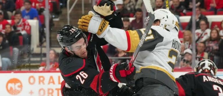 Carolina Hurricanes defenseman Sean Walker (26) checks Vegas Golden Knights center Brett Howden (21) during the second period at Lenovo Center