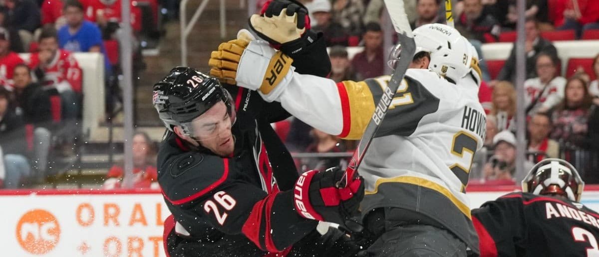 Carolina Hurricanes defenseman Sean Walker (26) checks Vegas Golden Knights center Brett Howden (21) during the second period at Lenovo Center