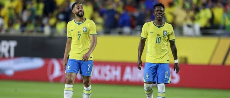 Brazil forward Matheus Cunha (7) and forward Vinícius Junior (10) walk off the field after the first half during an international friendly against Croatia at Camping World Stadium