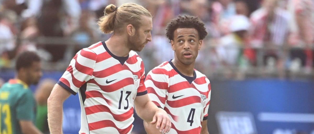 United States of America defender Tim Ream (13) with midfielder Tyler Adams (4) on the field in the first half at Bank of America Stadium