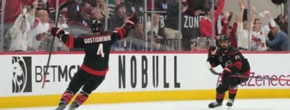 Carolina Hurricanes right wing Seth Jarvis (24) celebrates scoring with defenseman Shayne Gostisbehere (4) in overtime against the Vegas Golden Knights in game two of the 2026 Stanley Cup Final at Lenovo Center