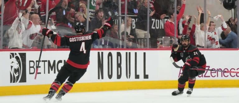 Carolina Hurricanes right wing Seth Jarvis (24) celebrates scoring with defenseman Shayne Gostisbehere (4) in overtime against the Vegas Golden Knights in game two of the 2026 Stanley Cup Final at Lenovo Center