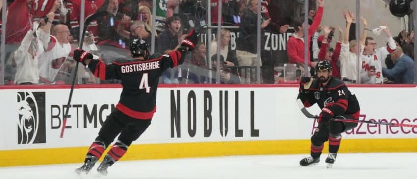 Carolina Hurricanes right wing Seth Jarvis (24) celebrates scoring with defenseman Shayne Gostisbehere (4) in overtime against the Vegas Golden Knights in game two of the 2026 Stanley Cup Final at Lenovo Center
