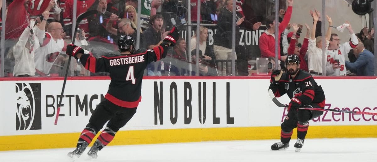 Carolina Hurricanes right wing Seth Jarvis (24) celebrates scoring with defenseman Shayne Gostisbehere (4) in overtime against the Vegas Golden Knights in game two of the 2026 Stanley Cup Final at Lenovo Center