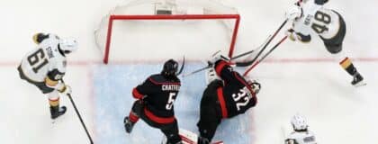 Carolina Hurricanes goaltender Brandon Bussi (32) freezes the puck against Vegas Golden Knights center Tomas Hertl (48) during the third period in game five of the 2026 Stanley Cup Final at Lenovo Center.