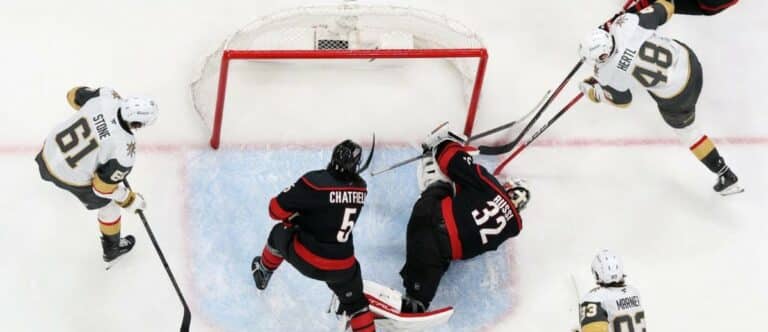 Carolina Hurricanes goaltender Brandon Bussi (32) freezes the puck against Vegas Golden Knights center Tomas Hertl (48) during the third period in game five of the 2026 Stanley Cup Final at Lenovo Center.