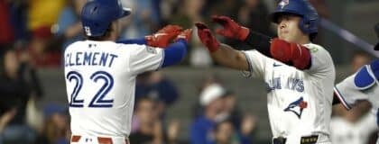 Toronto Blue Jays shortstop Ernie Clement (22) congratulates third baseman Kazuma Okamoto (7) on his two run home run against the Texas Rangers during the ninth inning at Rogers Centre