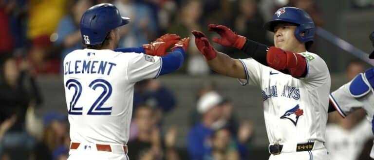 Toronto Blue Jays shortstop Ernie Clement (22) congratulates third baseman Kazuma Okamoto (7) on his two run home run against the Texas Rangers during the ninth inning at Rogers Centre