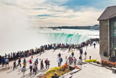 Crowds of tourists packed along the viewing platform at Horseshoe Falls, Niagara Falls, Ontario