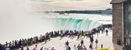 Crowds of tourists packed along the viewing platform at Horseshoe Falls, Niagara Falls, Ontario