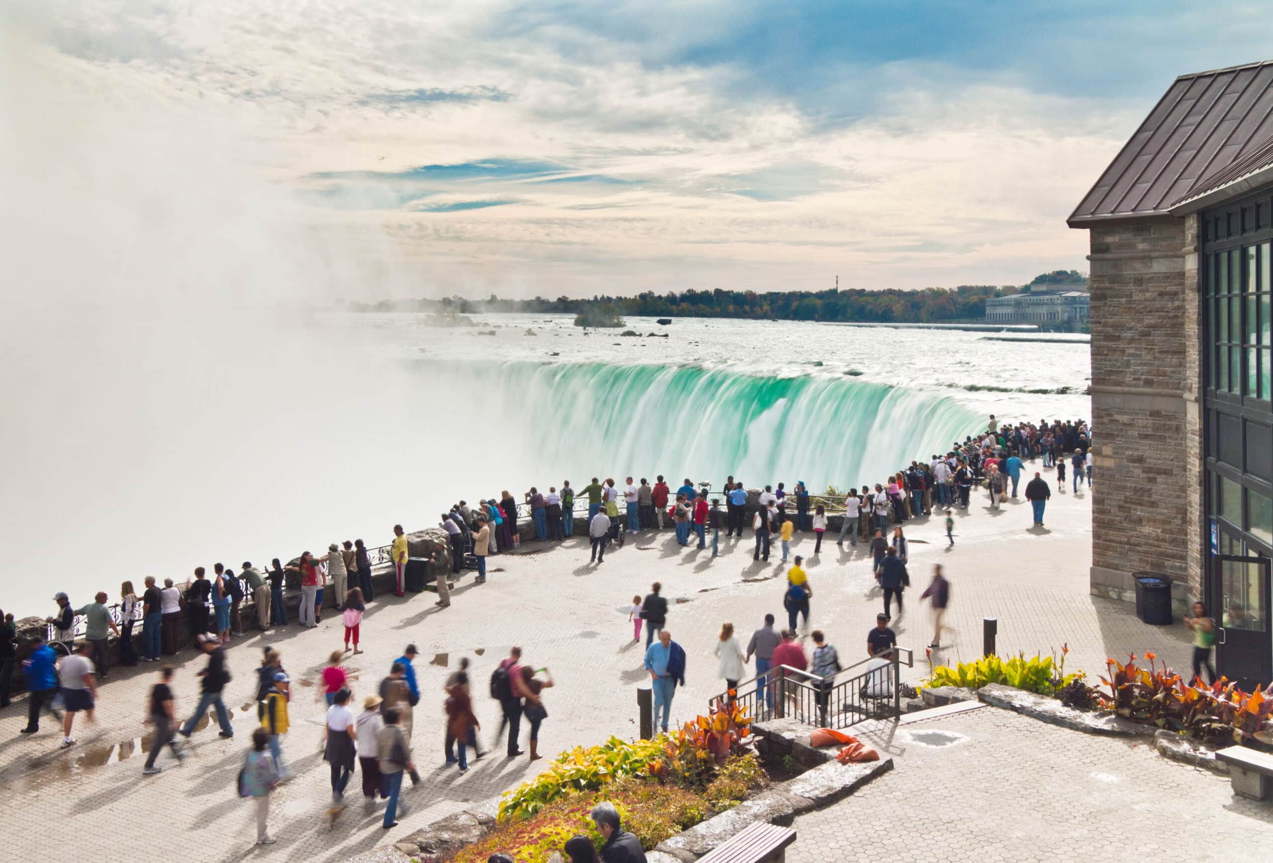 Crowds of tourists packed along the viewing platform at Horseshoe Falls, Niagara Falls, Ontario