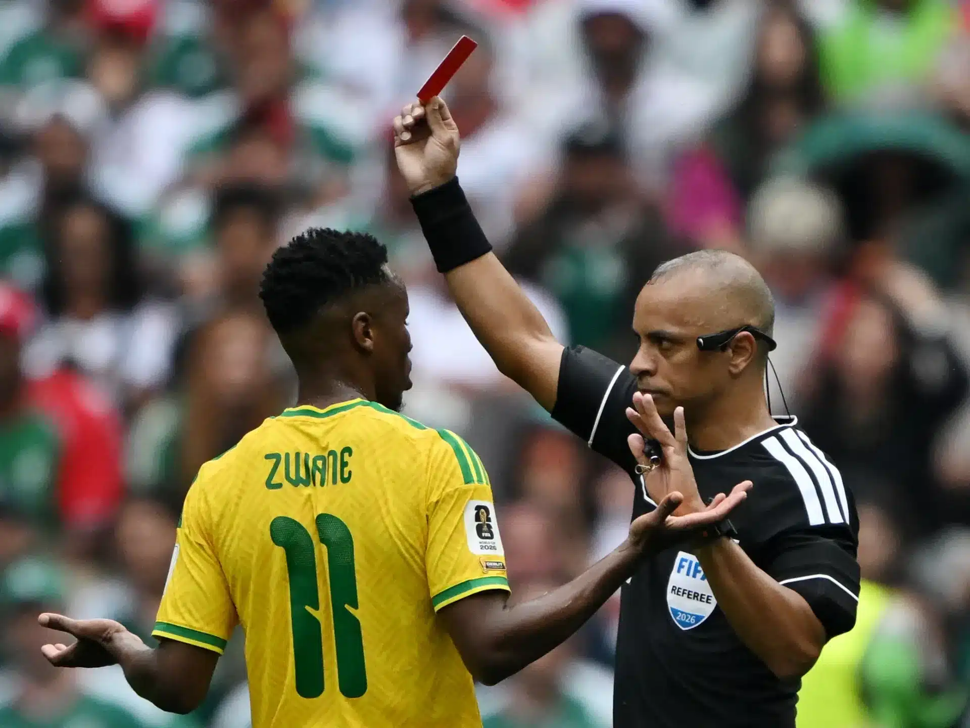 A referee shows a red card to a Brazilian player in a match on opening day of the 2026 World Cup