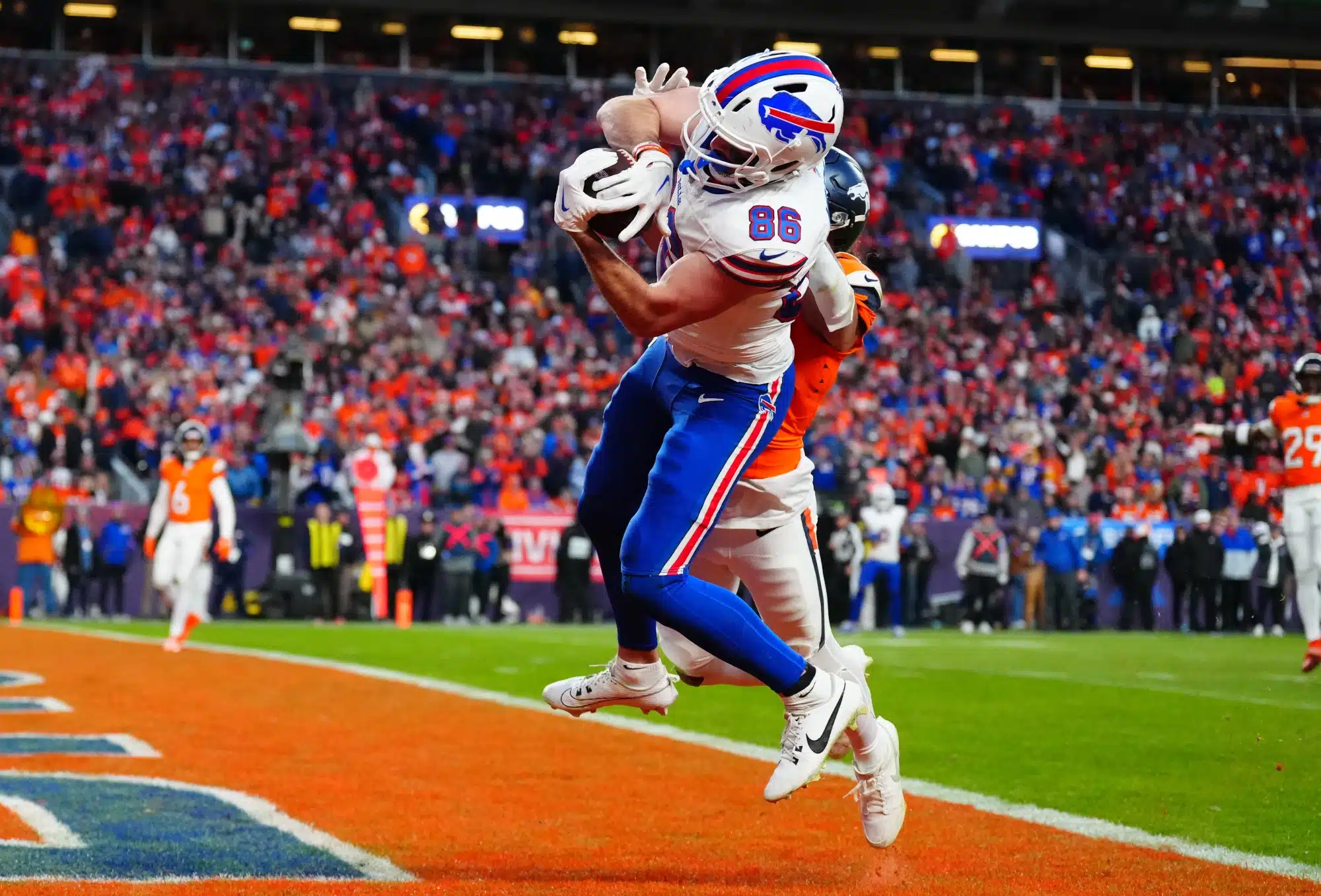 Jan 17, 2026; Denver, CO, USA; Buffalo Bills tight end Dalton Kincaid (86) catches a touchdown against Denver Broncos safety Talanoa Hufanga (9) during the fourth quarter of an AFC Divisional Round playoff game at Empower Field at Mile High.