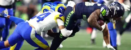 Jan 25, 2026; Seattle, WA, USA; Los Angeles Rams cornerback Cobie Durant (14) tackles Seattle Seahawks running back George Holani (36) during the first half in the 2026 NFC Championship Game at Lumen Field.